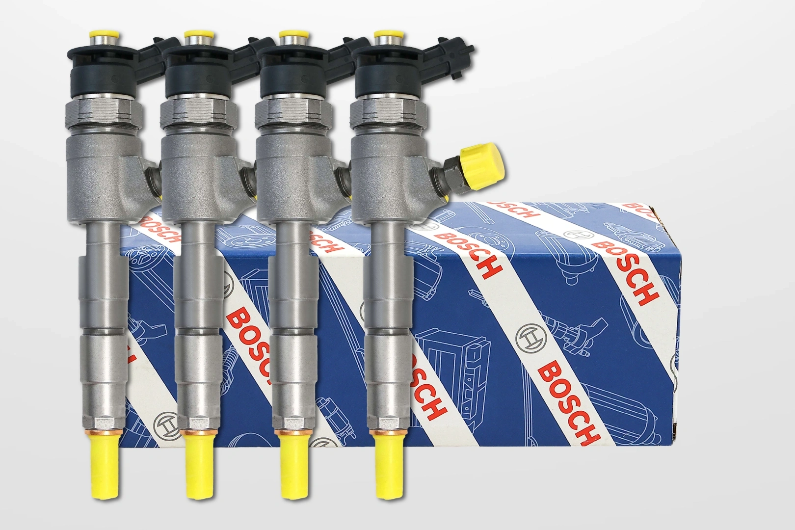 Wtryskiwacze Bosch na tle firmowego opakowania Metalowe wtryskiwacze Bosch Common Rail zaprezentowane na tle niebieskiego opakowania producenta
